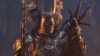 A knight in Lords of the Fallen holding a wooden talisman