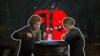 Students at a cauldron with the Nintendo Switch logo behind them.
